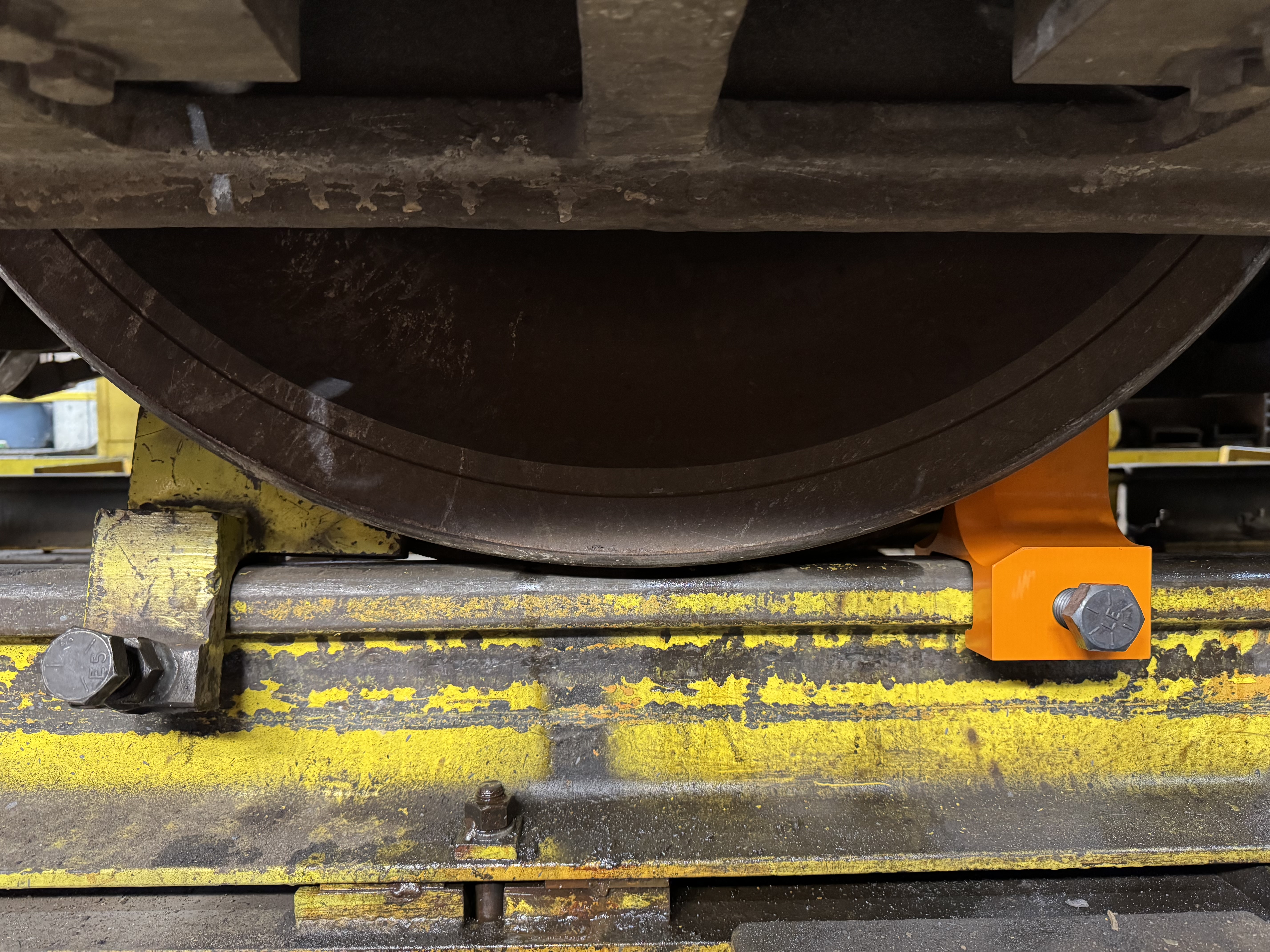 One piece rail clamp to be used on locomotive drop tables. 