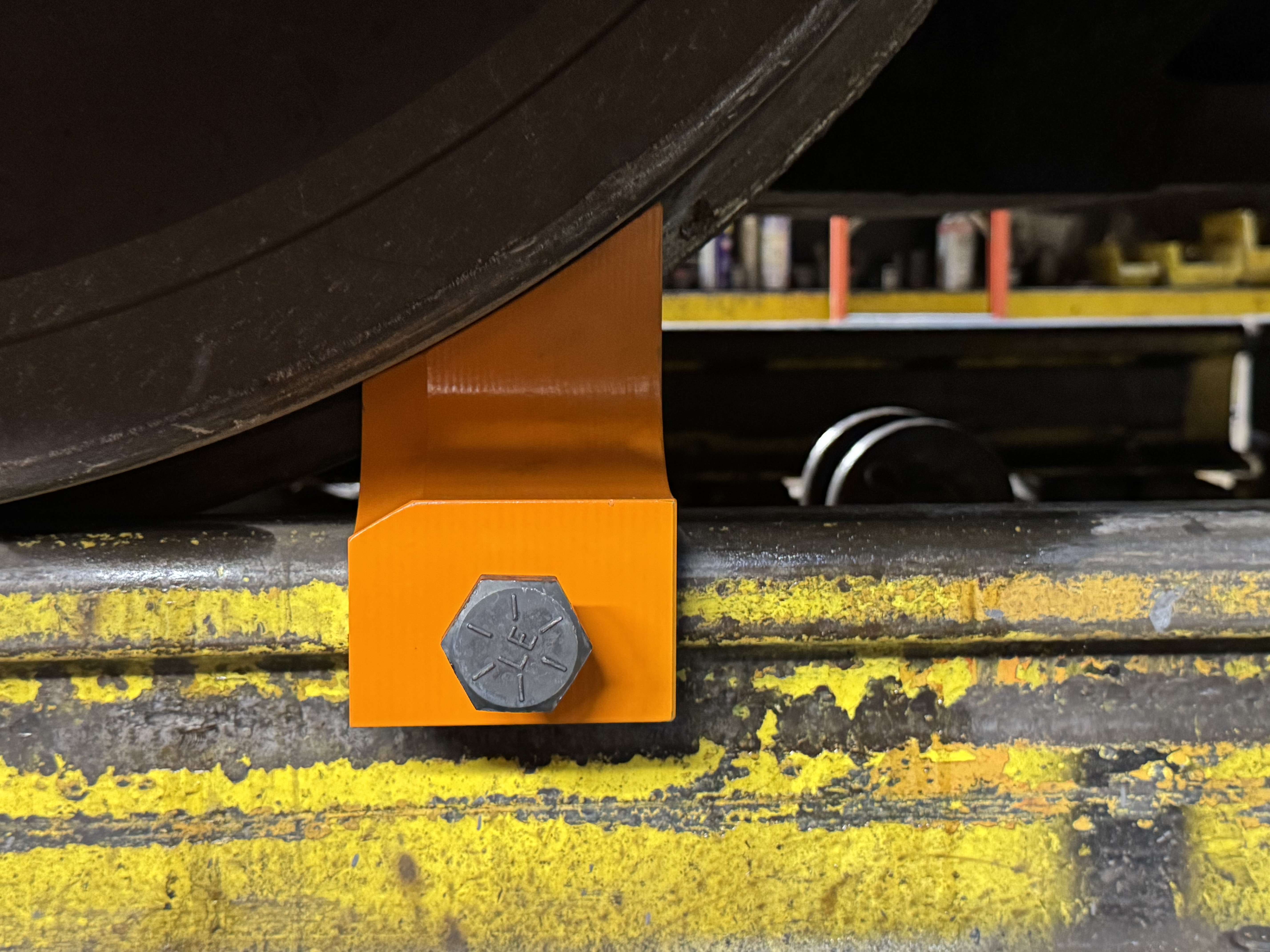 One piece rail clamp to be used on locomotive drop tables. 