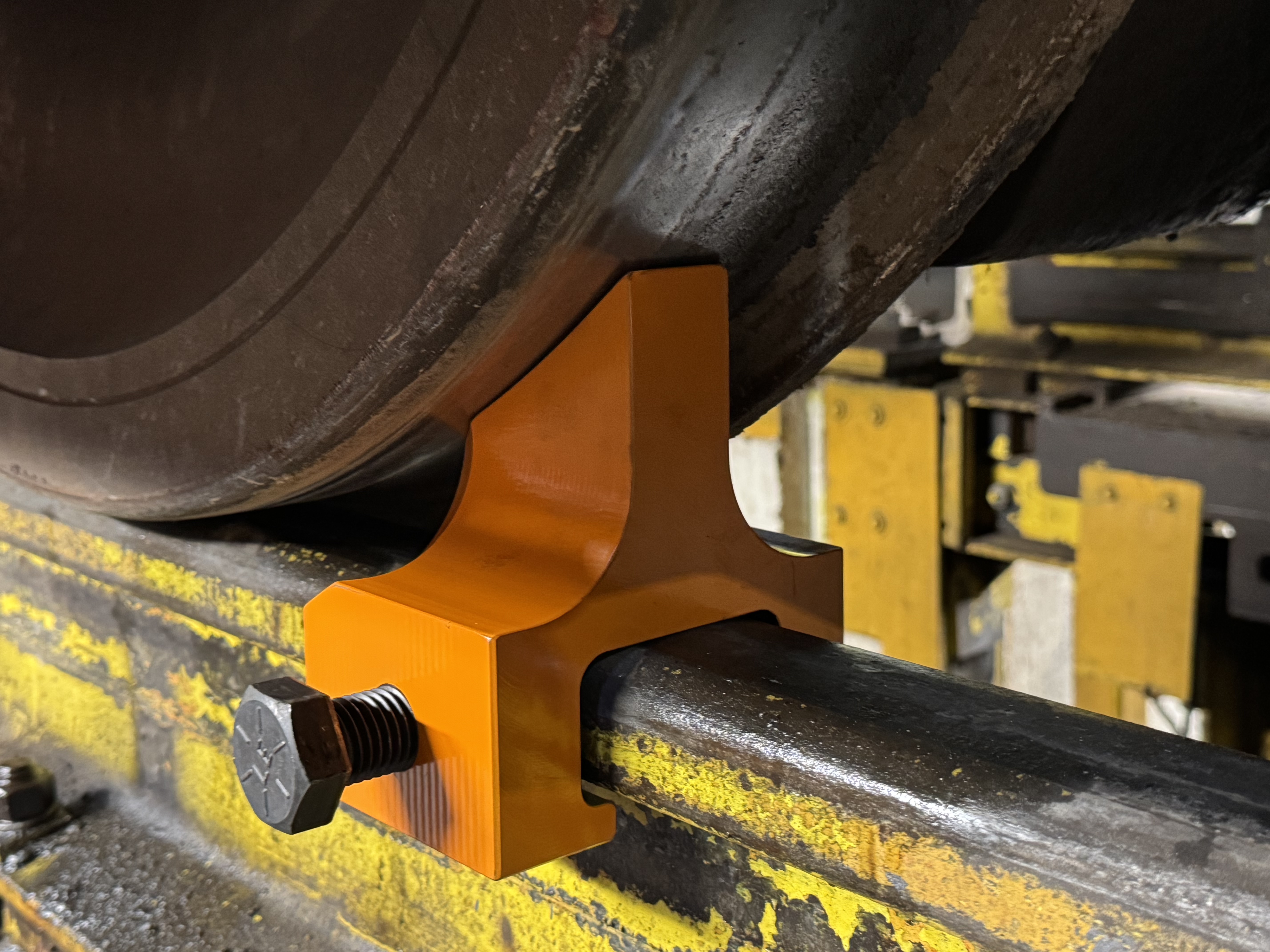 One piece rail clamp to be used on locomotive drop tables. 